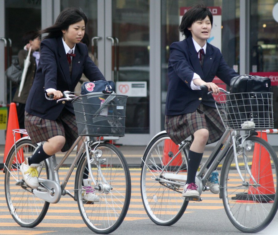 Girls taking photos on bicycles